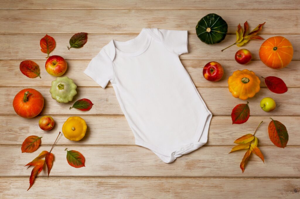 White baby short sleeve bodysuit mockup with fall decor
